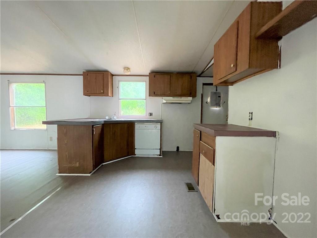 6507 Robinson Bridge Road Morven, NC 28119 - Photo 8 of 15 a kitchen with stainless steel appliances wooden cabinets and a sink