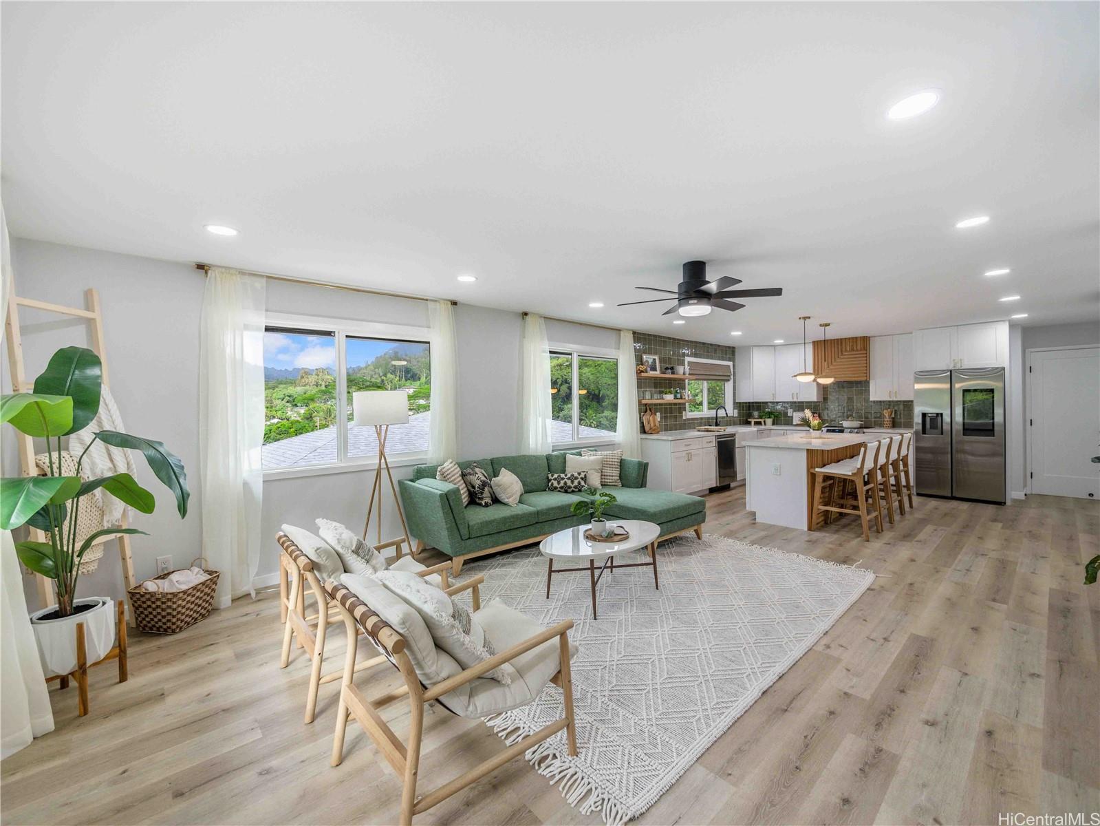a living room with furniture and kitchen view