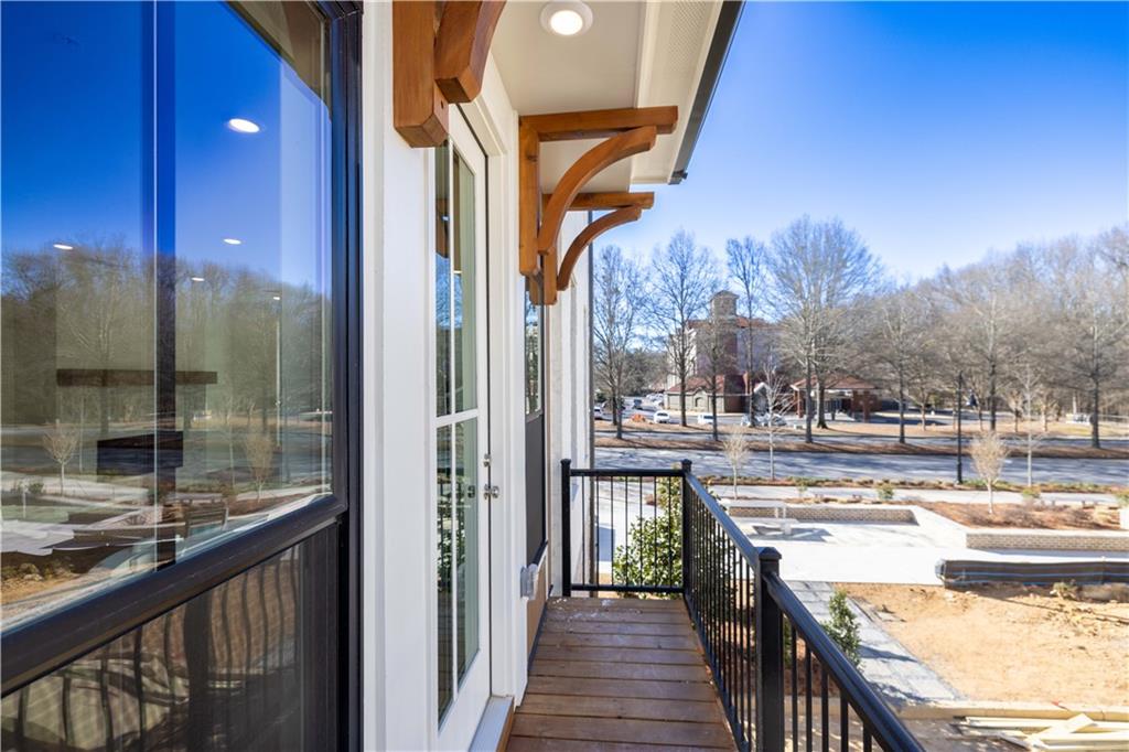 362 Olmstead Way, Unit 23 Alpharetta, GA 30022 - Photo 11 of 43 a view of a balcony and a kitchen with wooden floor