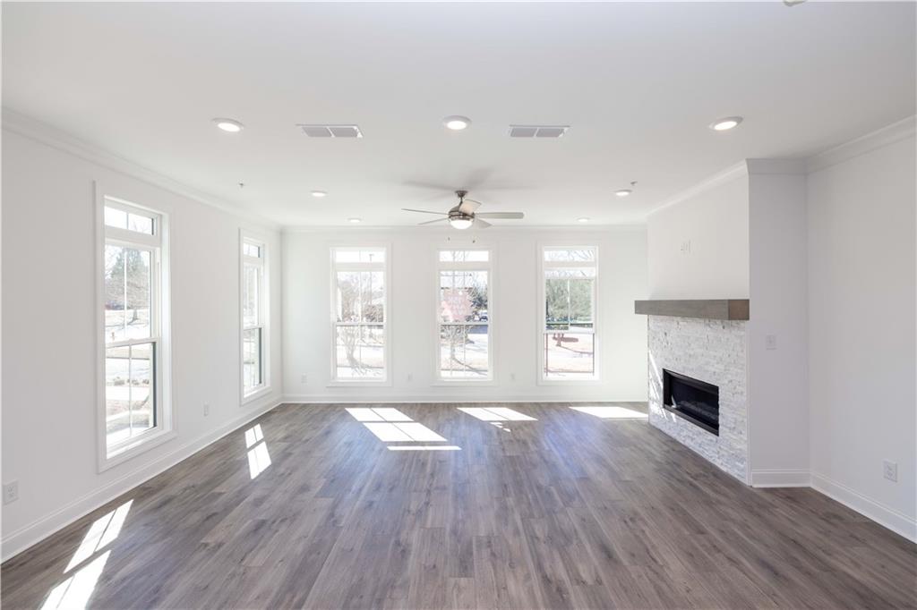 362 Olmstead Way, Unit 23 Alpharetta, GA 30022 - Photo 12 of 43 a view of an empty room with wooden floor and a window