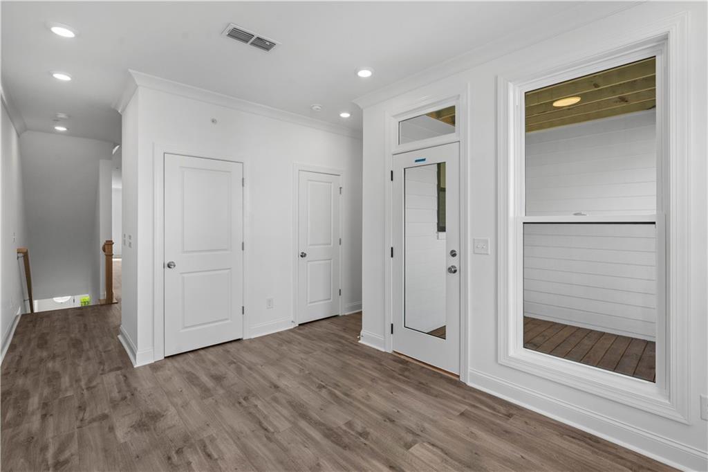 362 Olmstead Way, Unit 23 Alpharetta, GA 30022 - Photo 16 of 43 a view of a hallway with wooden floor