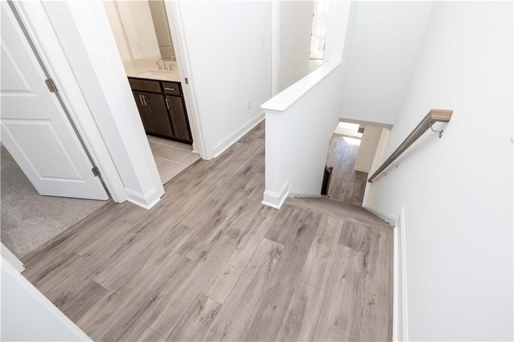 362 Olmstead Way, Unit 23 Alpharetta, GA 30022 - Photo 19 of 43 a view of a livingroom with wooden floor and staircase