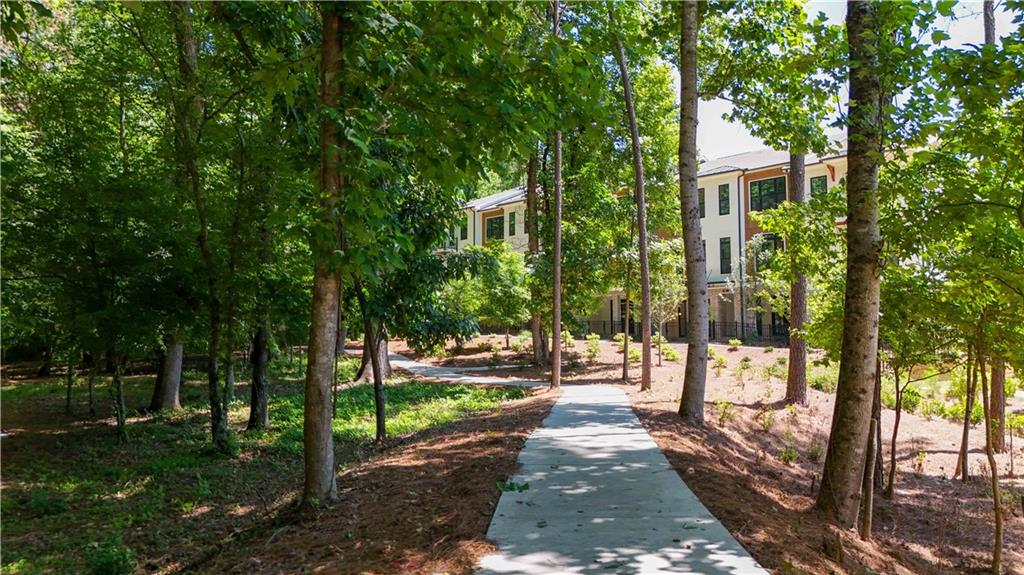 362 Olmstead Way, Unit 23 Alpharetta, GA 30022 - Photo 39 of 43 a view of a yard with plants and trees