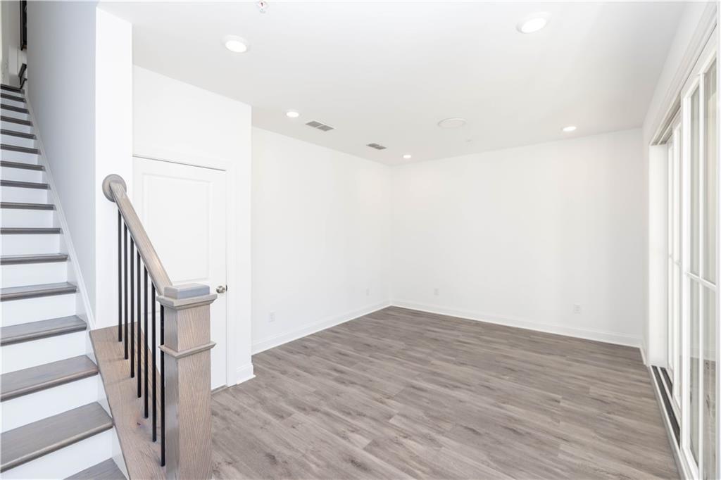 362 Olmstead Way, Unit 23 Alpharetta, GA 30022 - Photo 6 of 43 wooden floor in an empty room with a window