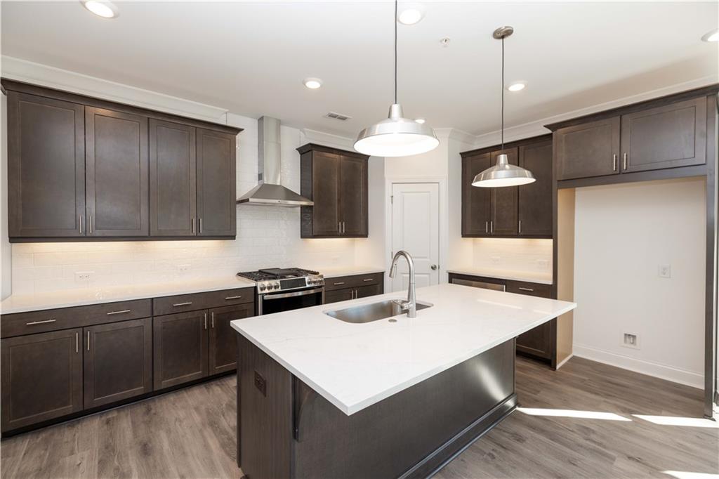 362 Olmstead Way, Unit 23 Alpharetta, GA 30022 - Photo 8 of 43 a kitchen with a sink a counter space cabinets and appliances