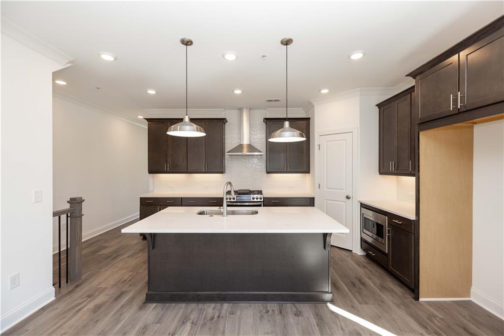 362 Olmstead Way, Unit 23 Alpharetta, GA 30022 - Photo 9 of 43 a large kitchen with stainless steel appliances kitchen island a large island in the center