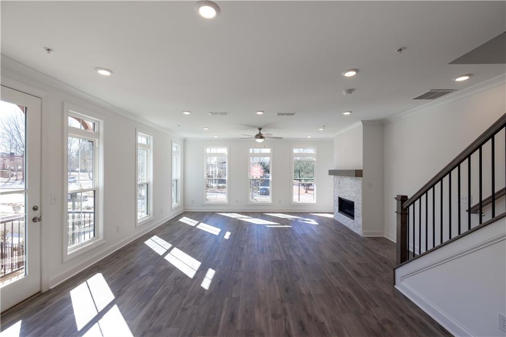 362 Olmstead Way, Unit 23 Alpharetta, GA 30022 - Photo 10 of 43 a view of an empty room with wooden floor and a window