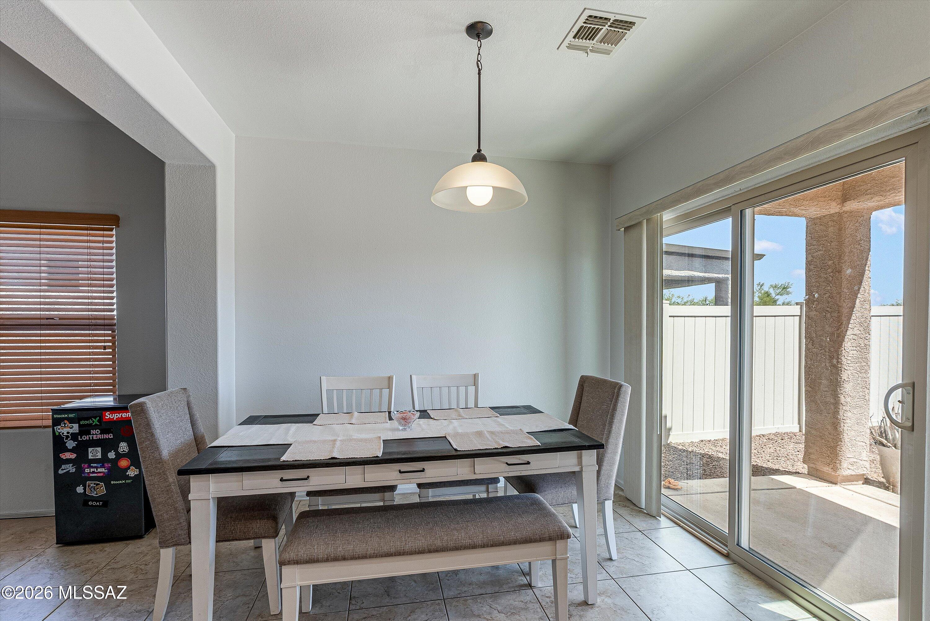 21163 East Treasure Road Red Rock, AZ 85145 - Photo 9 of 35 a dining room with a table and chairs