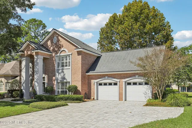 a view of a a dining room with furniture window and wooden floor