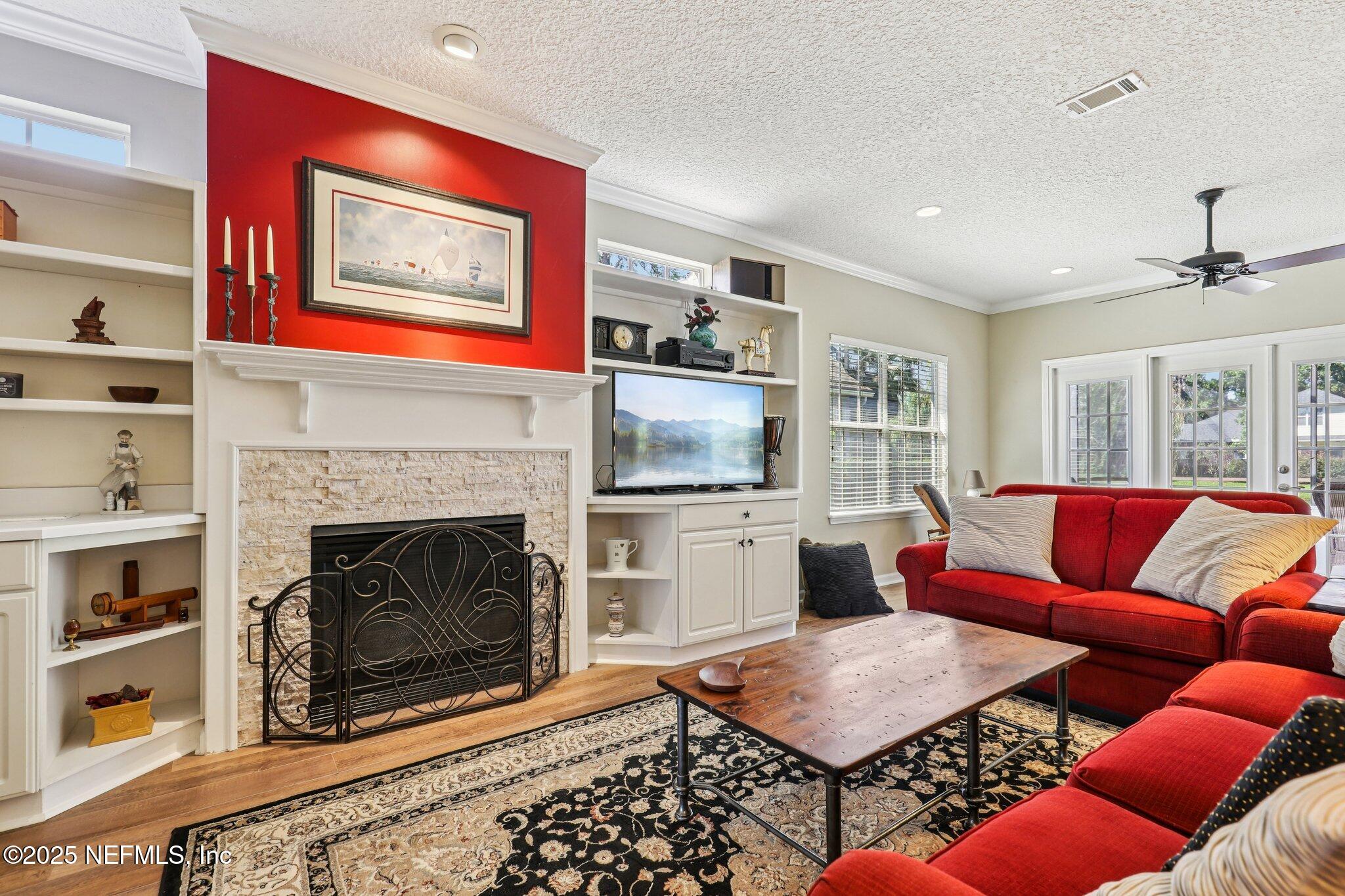 1432 Course View Drive Fleming Island, FL 32003 - Photo 24 of 83 a living room with furniture a flat screen tv and a fireplace
