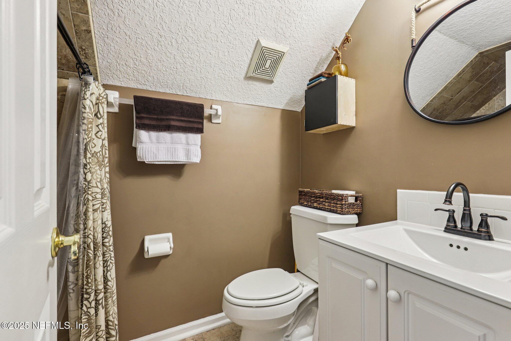 1432 Course View Drive Fleming Island, FL 32003 - Photo 40 of 83 a bathroom with a toilet sink and mirror
