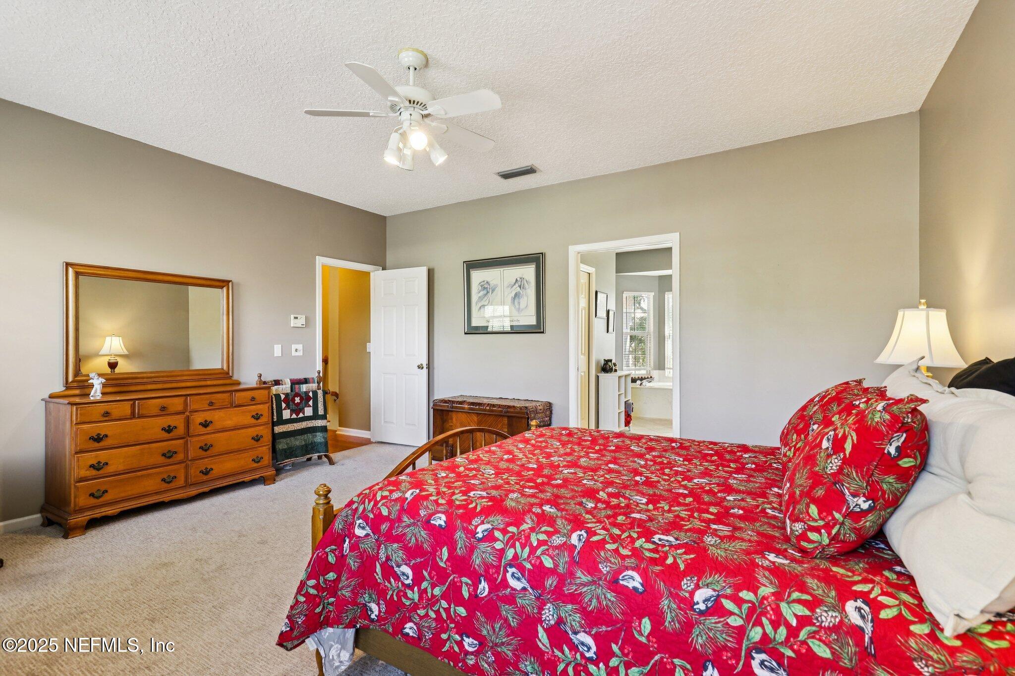 1432 Course View Drive Fleming Island, FL 32003 - Photo 43 of 83 a bedroom with a bed and a dresser