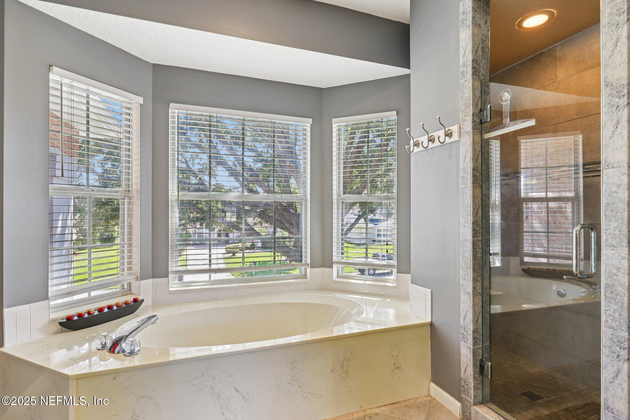 1432 Course View Drive Fleming Island, FL 32003 - Photo 46 of 83 a bath tub sitting in a bathroom next to a window