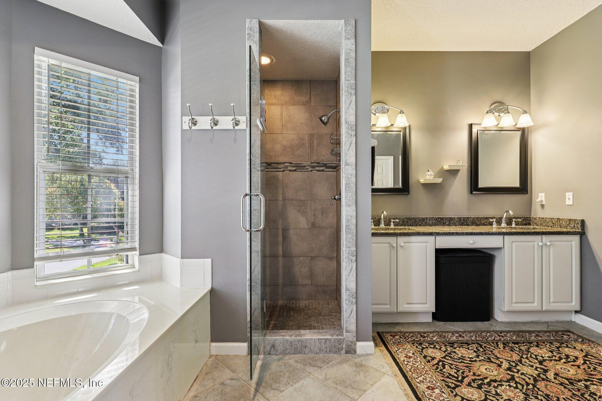 1432 Course View Drive Fleming Island, FL 32003 - Photo 47 of 83 a spacious bathroom with a granite countertop tub sink and glass door