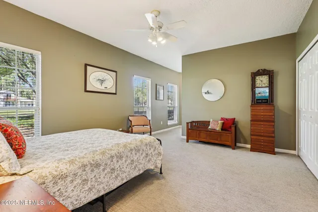 a view of a chairs and table in patio with a lake view