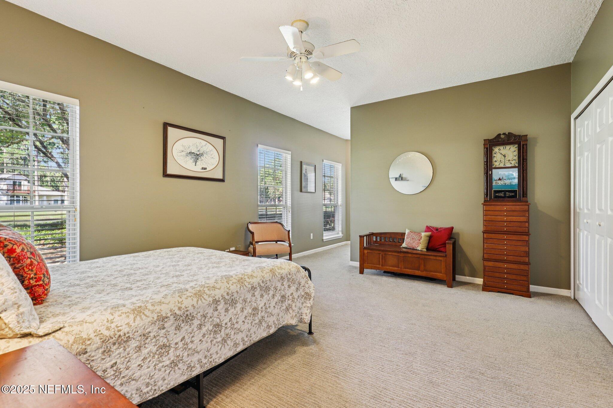1432 Course View Drive Fleming Island, FL 32003 - Photo 49 of 83 a bedroom with bed and a chandelier