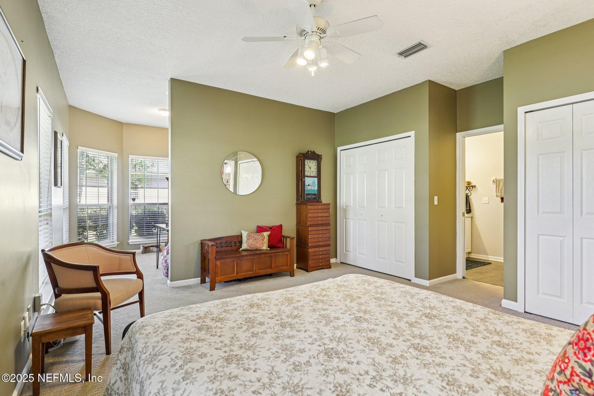 1432 Course View Drive Fleming Island, FL 32003 - Photo 50 of 83 a bedroom with a bed and a chandelier