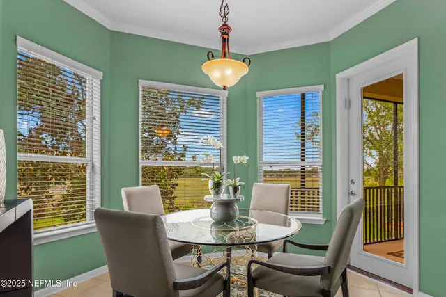 a view of a dining room with furniture and windows