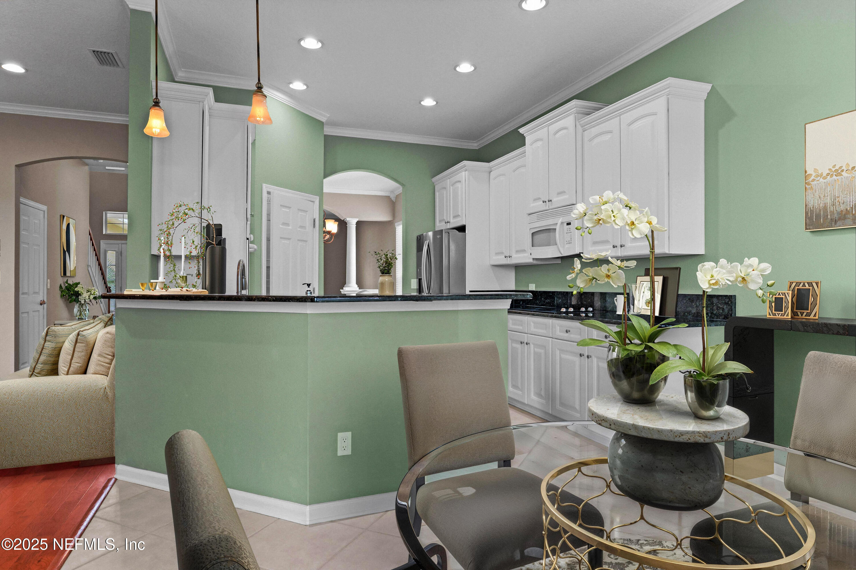 96218 Windsor Drive Yulee, FL 32097 - Photo 12 of 53 a kitchen with stainless steel appliances a dining table and chairs