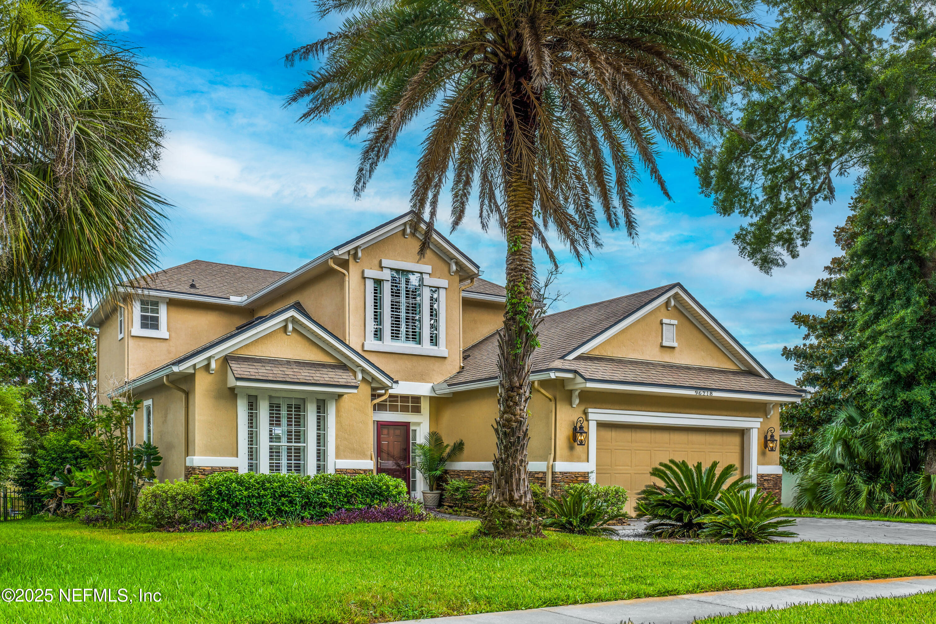 96218 Windsor Drive Yulee, FL 32097 - Photo 13 of 53 a front view of a house with a garden