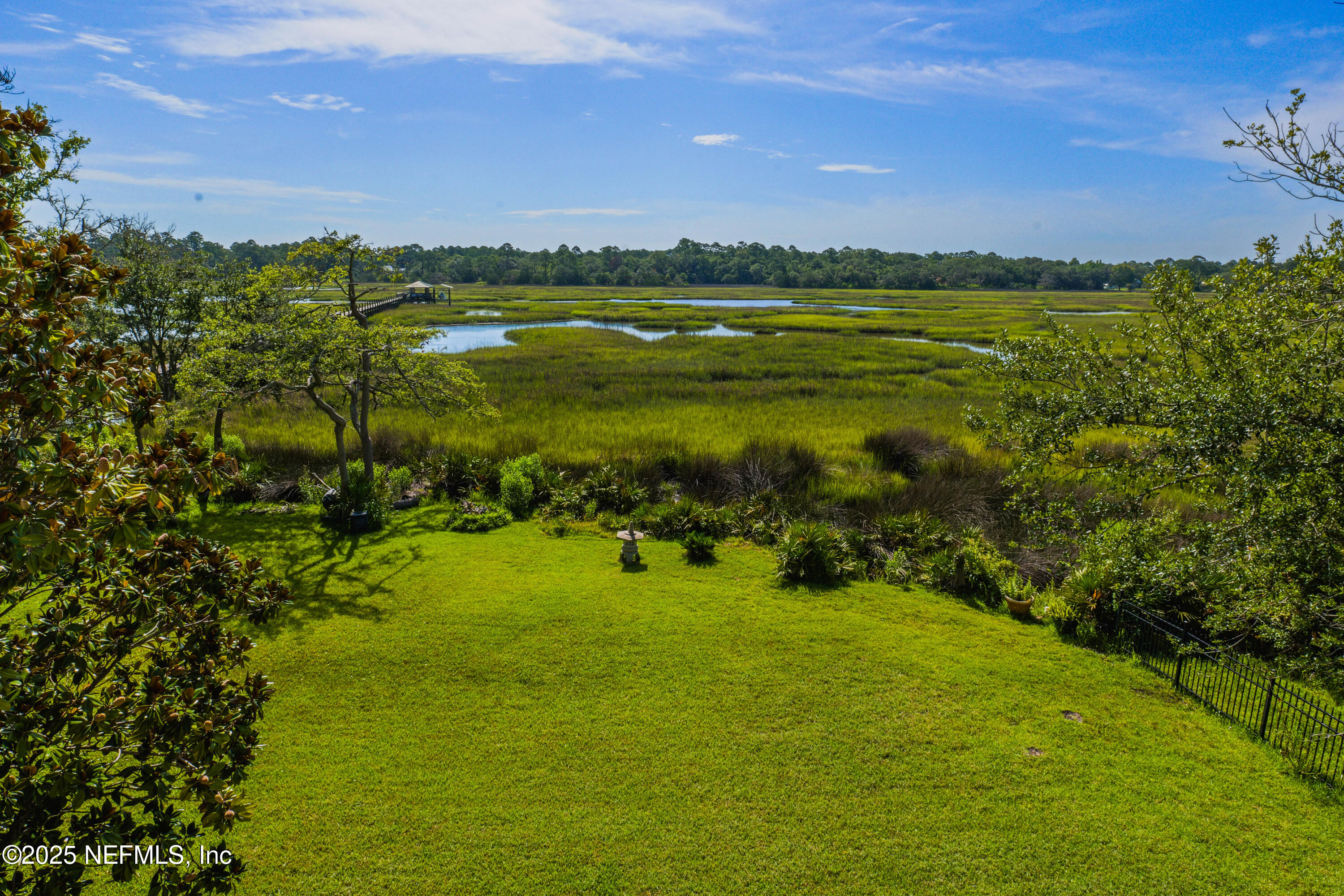 96218 Windsor Drive Yulee, FL 32097 - Photo 18 of 53 a view of a lake with houses in the back