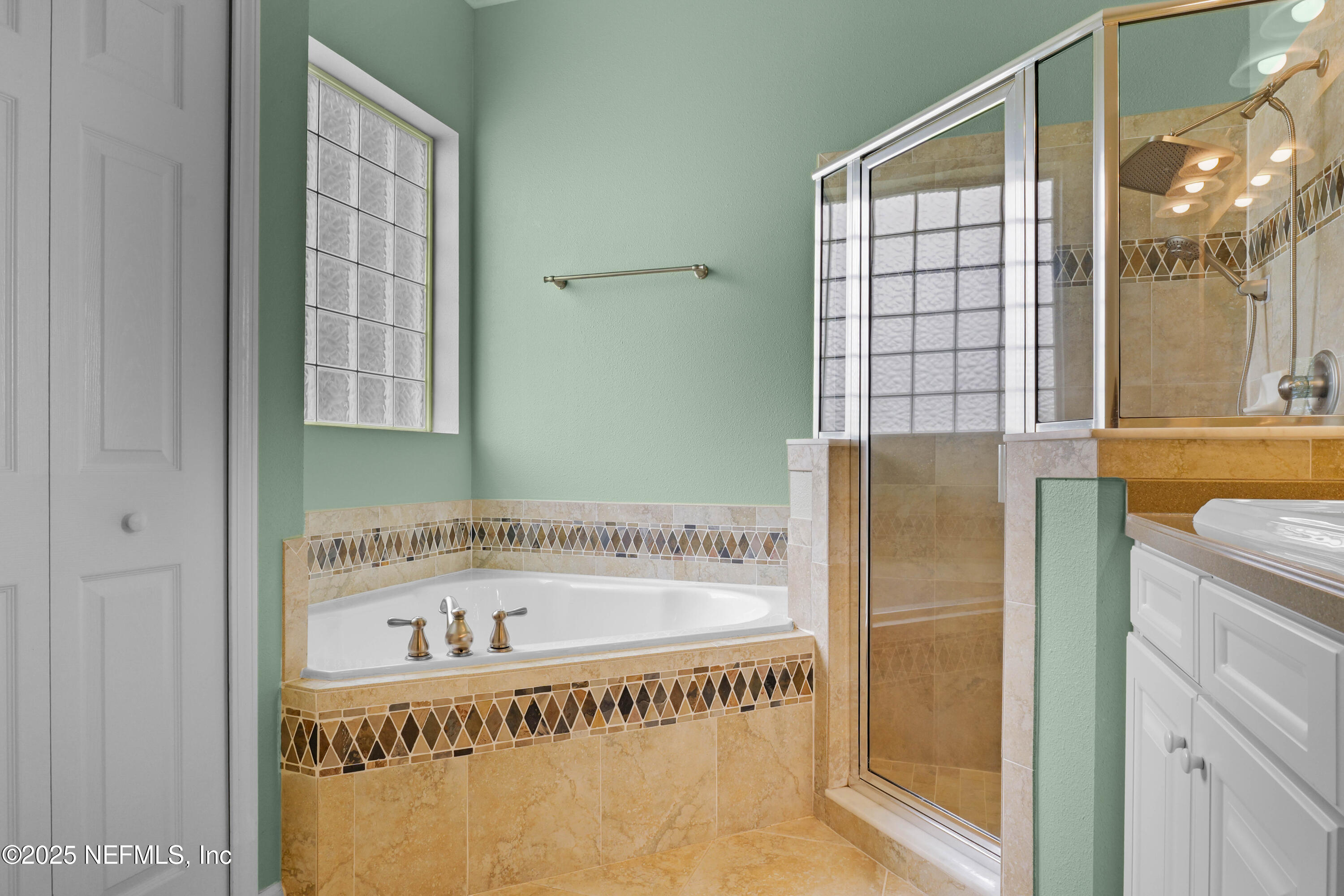 96218 Windsor Drive Yulee, FL 32097 - Photo 21 of 53 a bathroom with a bathtub and a shower