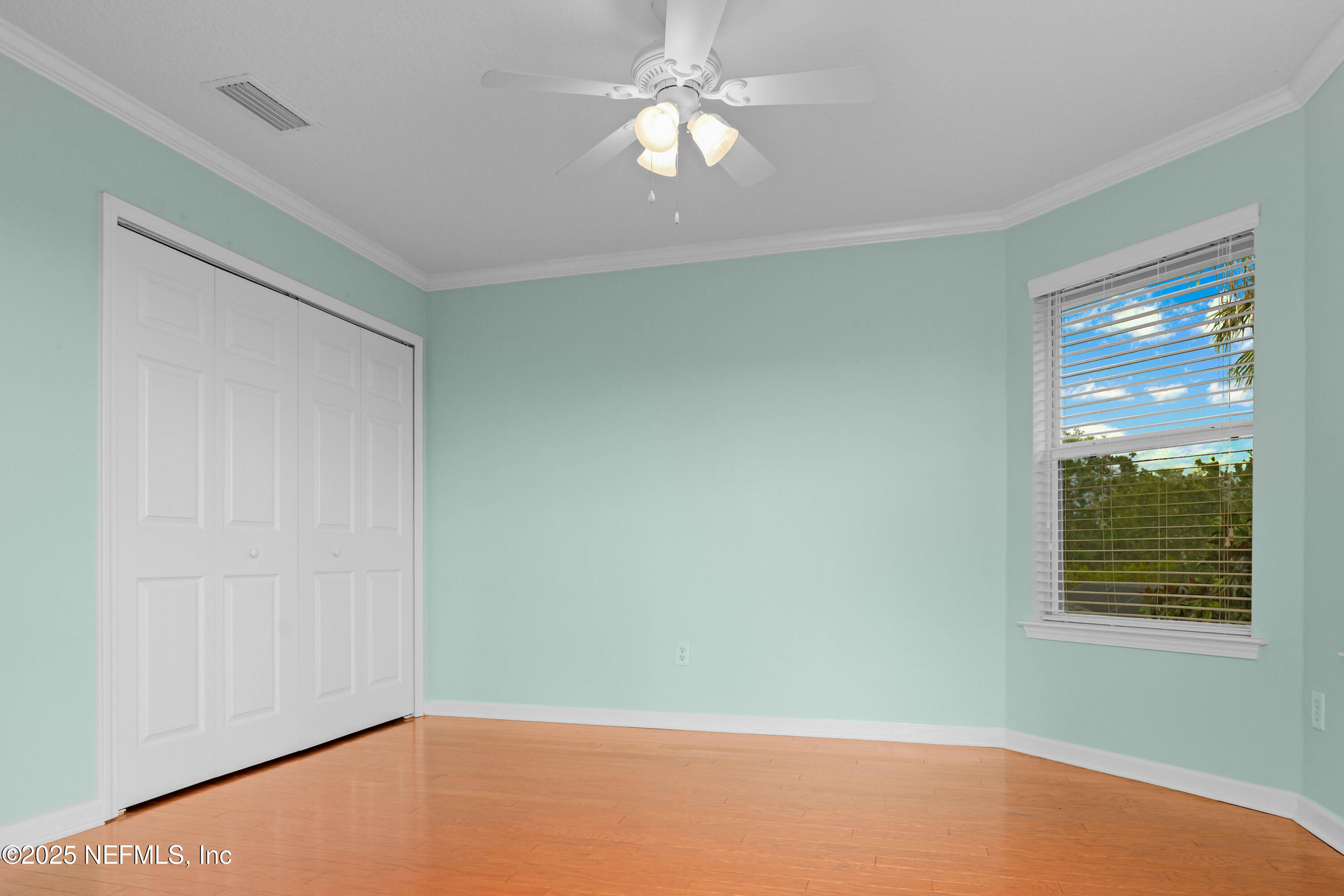 96218 Windsor Drive Yulee, FL 32097 - Photo 22 of 53 a view of an empty room with window and chandelier fan