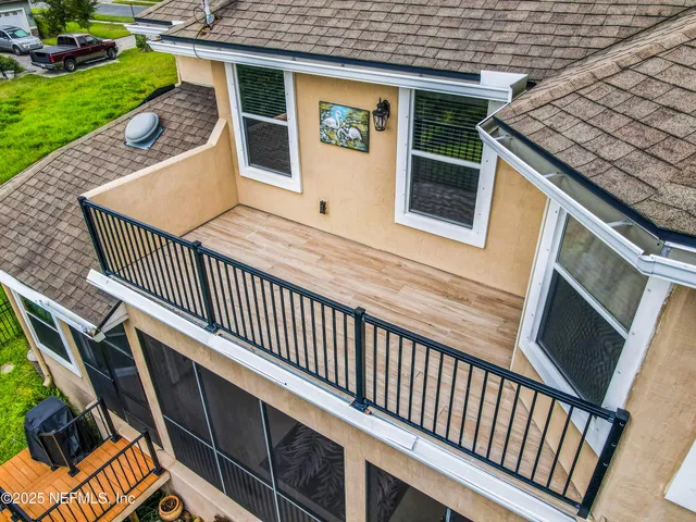 a balcony with wooden floor and fence