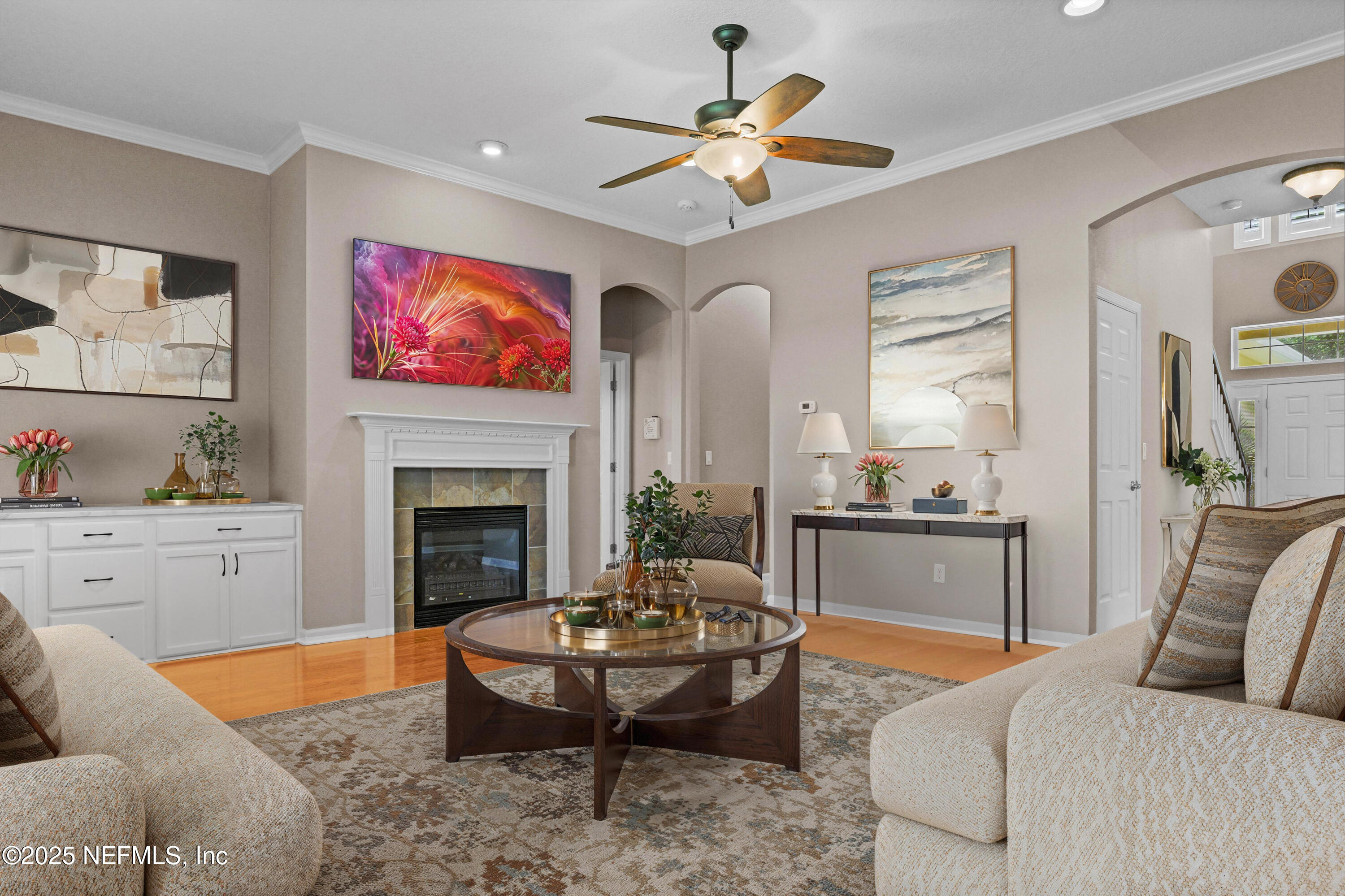 96218 Windsor Drive Yulee, FL 32097 - Photo 24 of 53 a living room with furniture a fireplace and kitchen view