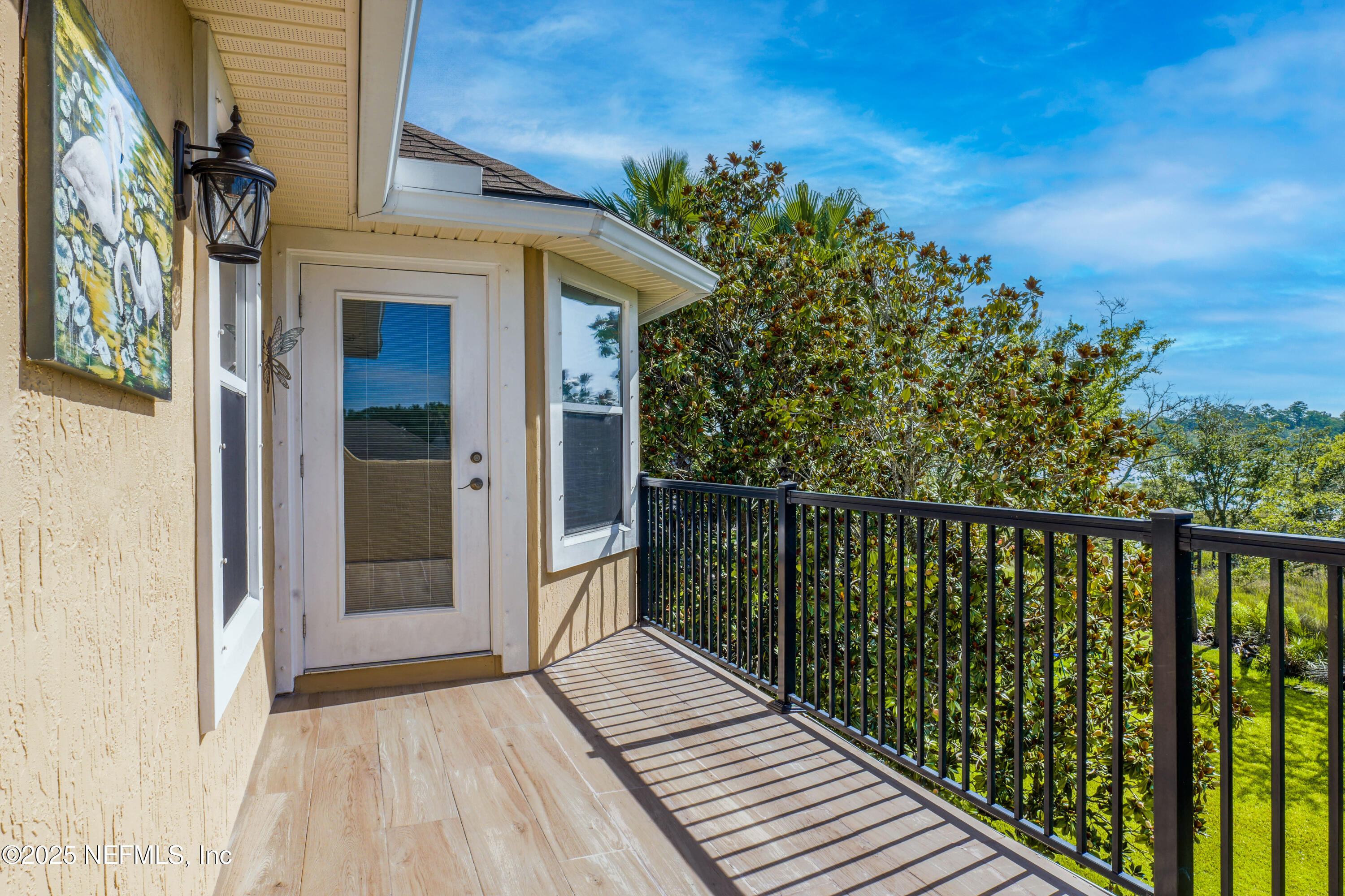 96218 Windsor Drive Yulee, FL 32097 - Photo 25 of 53 a balcony with wooden floor and fence