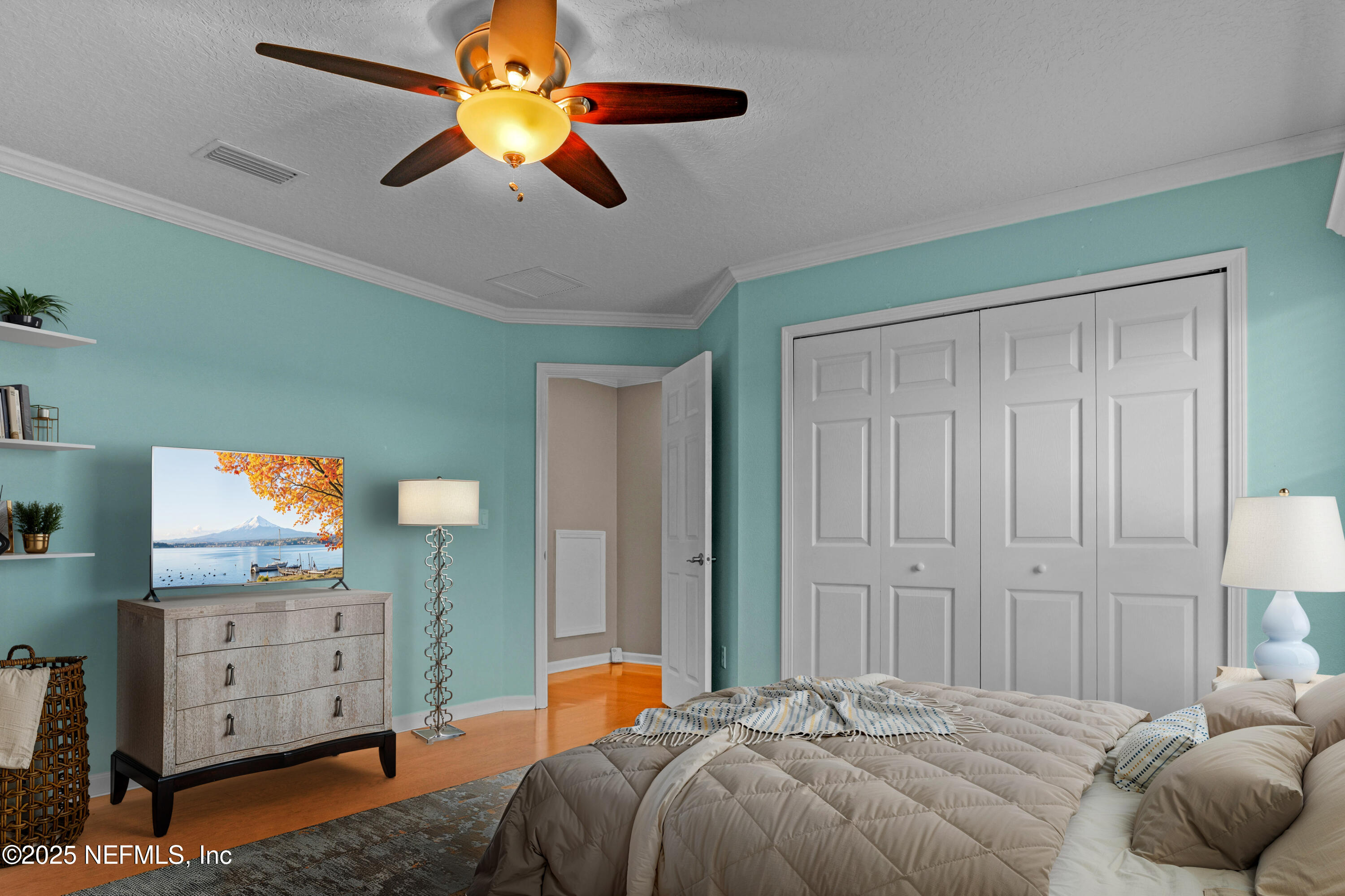 96218 Windsor Drive Yulee, FL 32097 - Photo 29 of 53 a bedroom with a bed and a chandelier