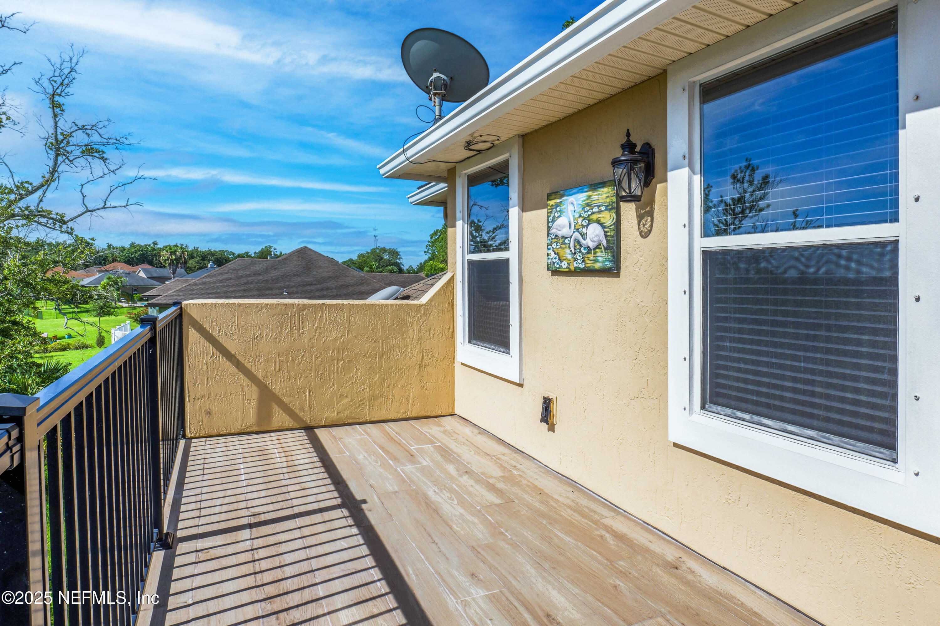 96218 Windsor Drive Yulee, FL 32097 - Photo 34 of 53 a view of balcony with wooden floor and fence
