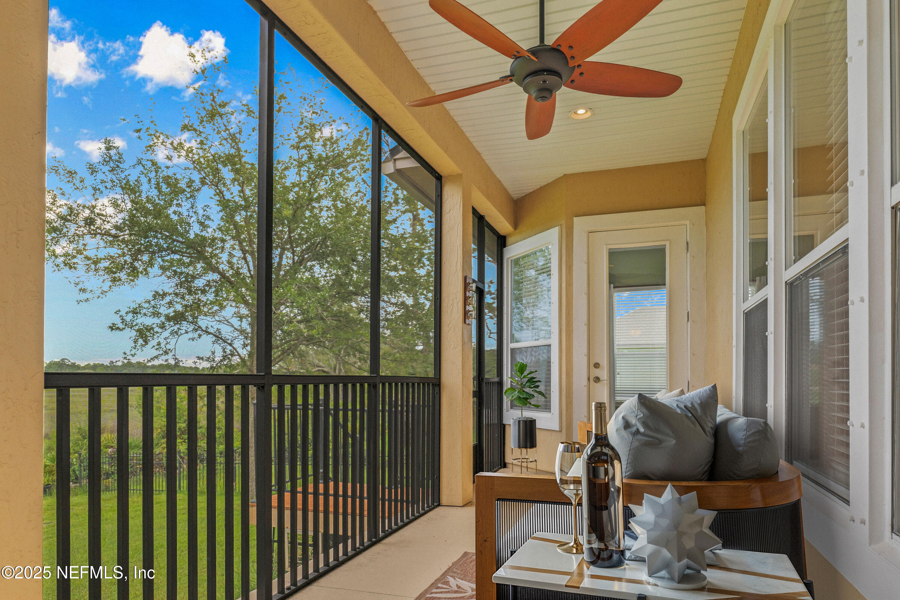 96218 Windsor Drive Yulee, FL 32097 - Photo 38 of 53 a living room with furniture and a floor to ceiling window