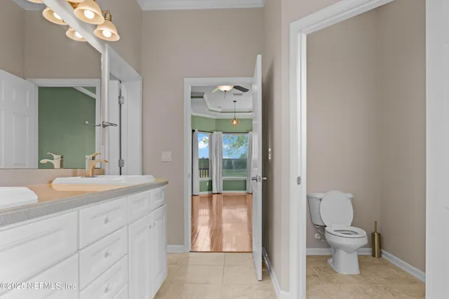 a bathroom with a sink a toilet and a shower curtain