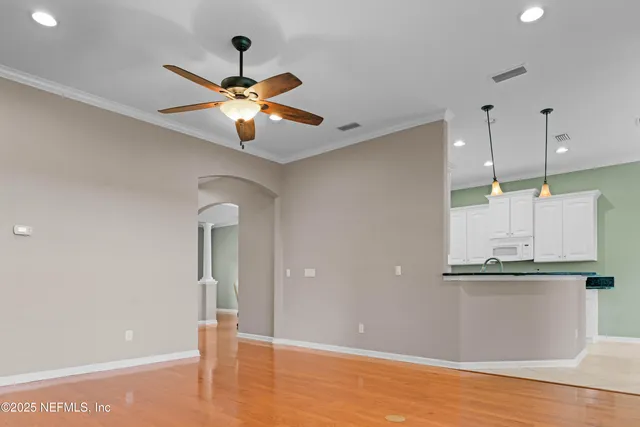 a view of a kitchen with cabinets and a ceiling fan