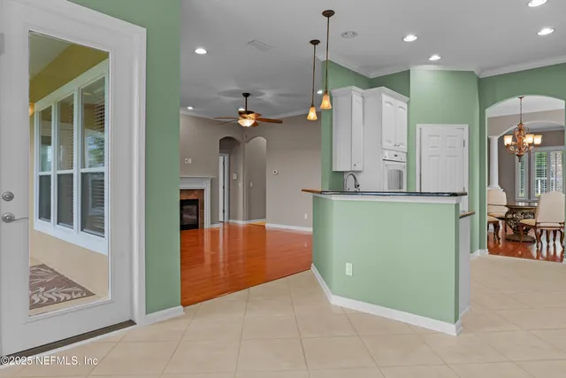 a view of an empty room with cabinet and fireplace