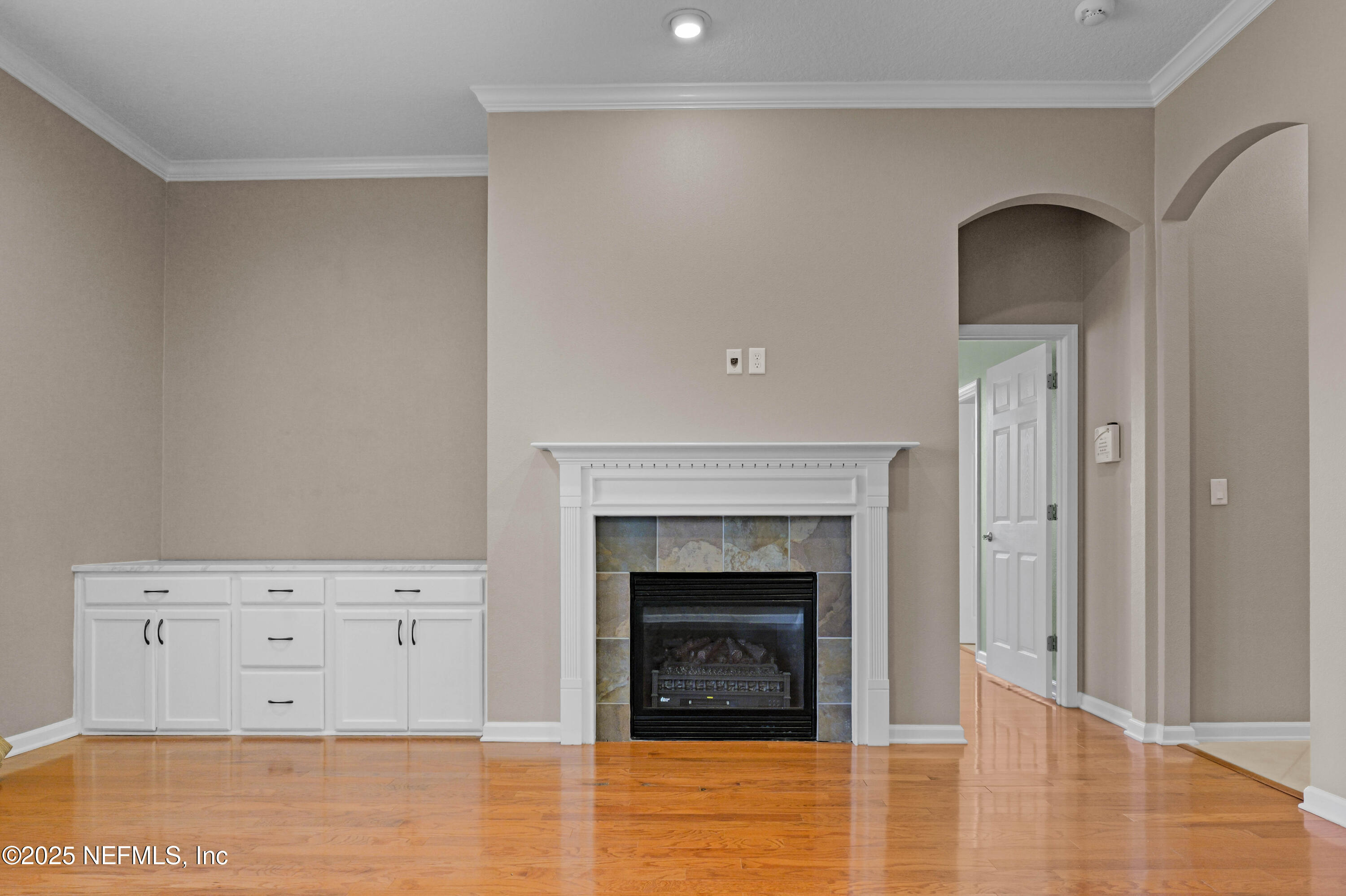 96218 Windsor Drive Yulee, FL 32097 - Photo 45 of 53 a view of an empty room with cabinet and fireplace