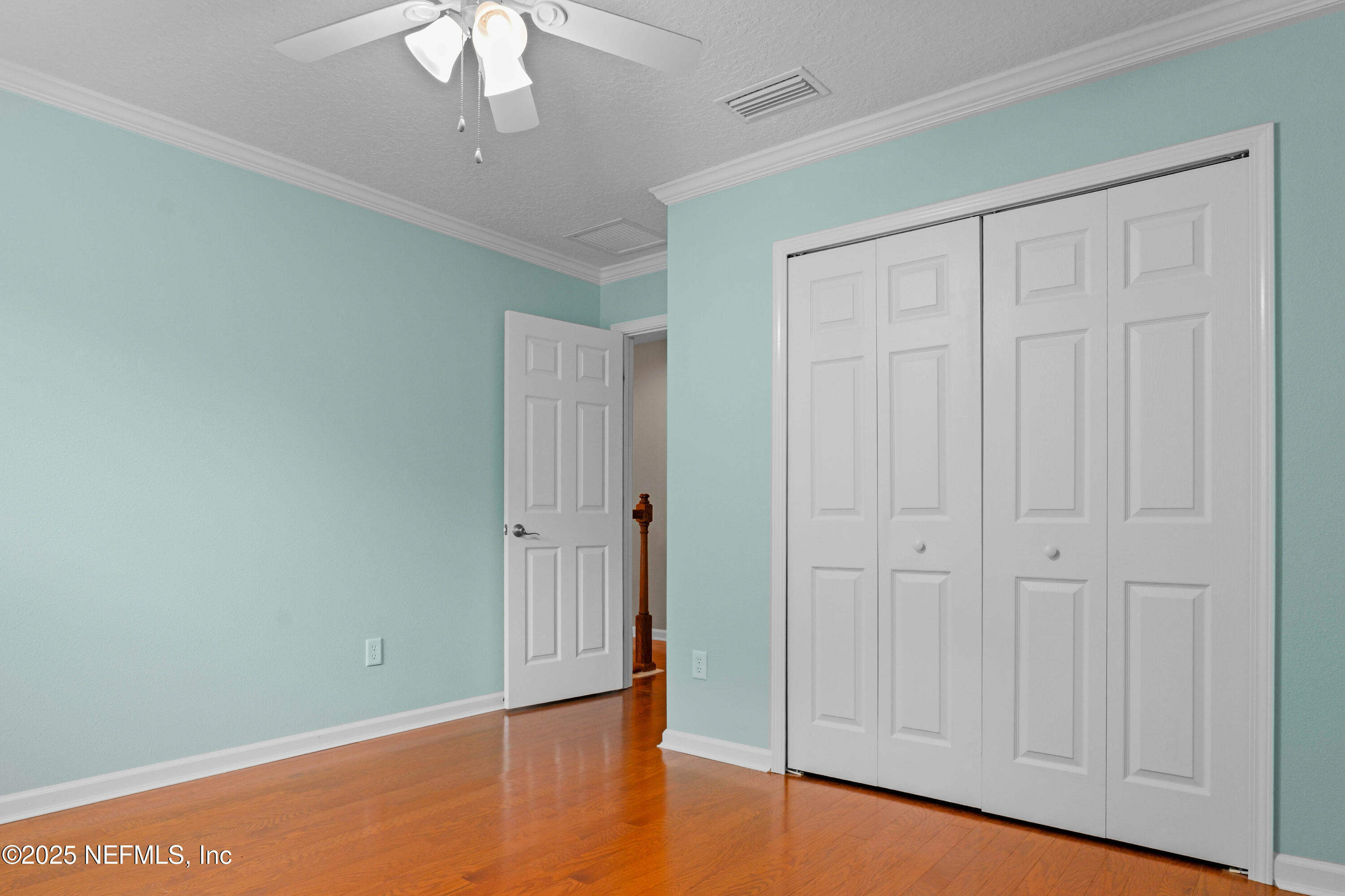 96218 Windsor Drive Yulee, FL 32097 - Photo 52 of 53 an empty room with wooden floor closet and windows