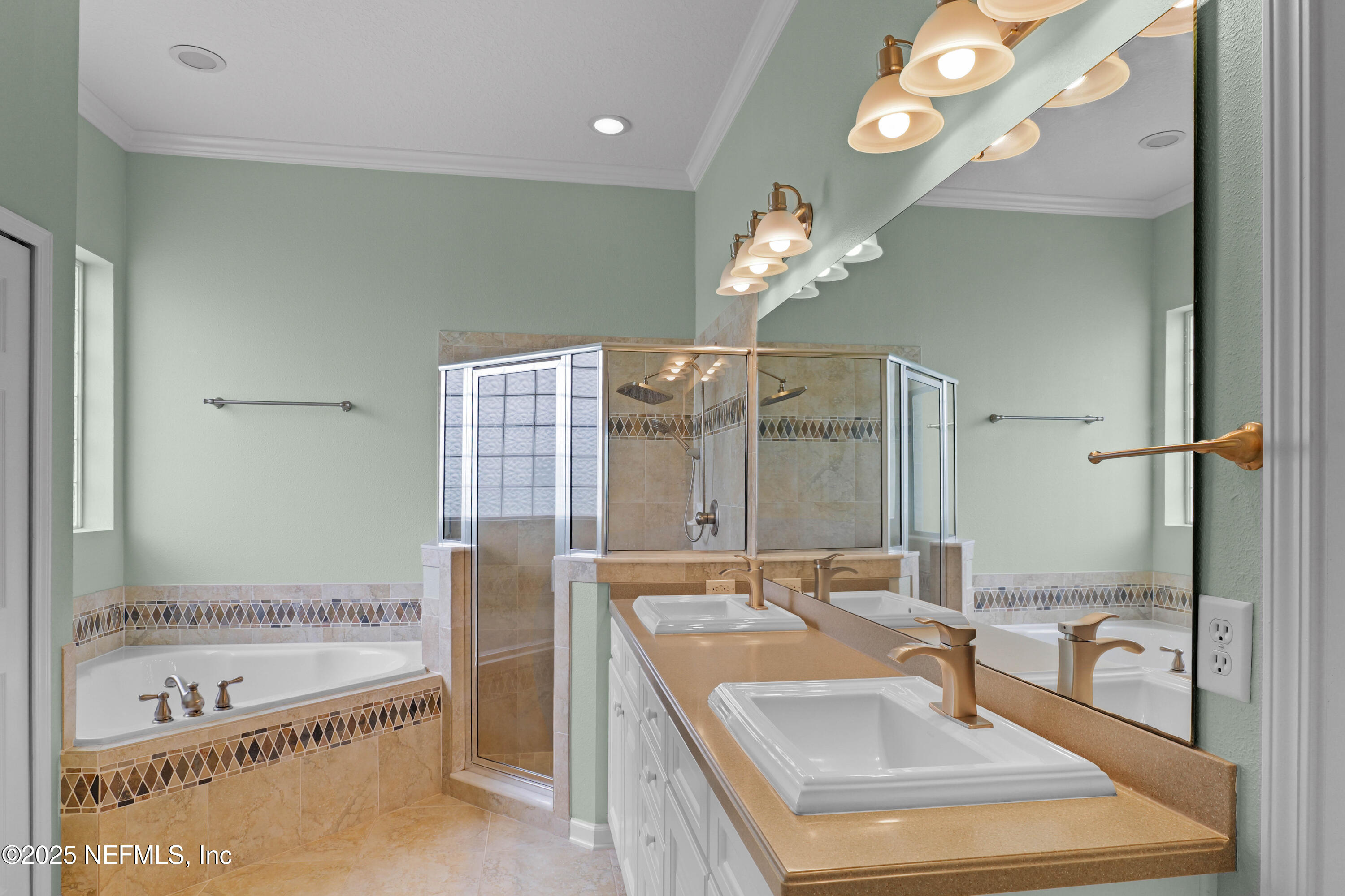 96218 Windsor Drive Yulee, FL 32097 - Photo 53 of 53 a bathroom with a tub a sink and a large mirror