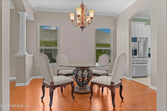 a view of a dining room with furniture wooden floor and chandelier