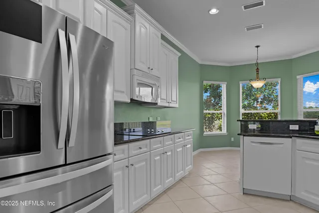 a kitchen with stainless steel appliances a sink stove and refrigerator