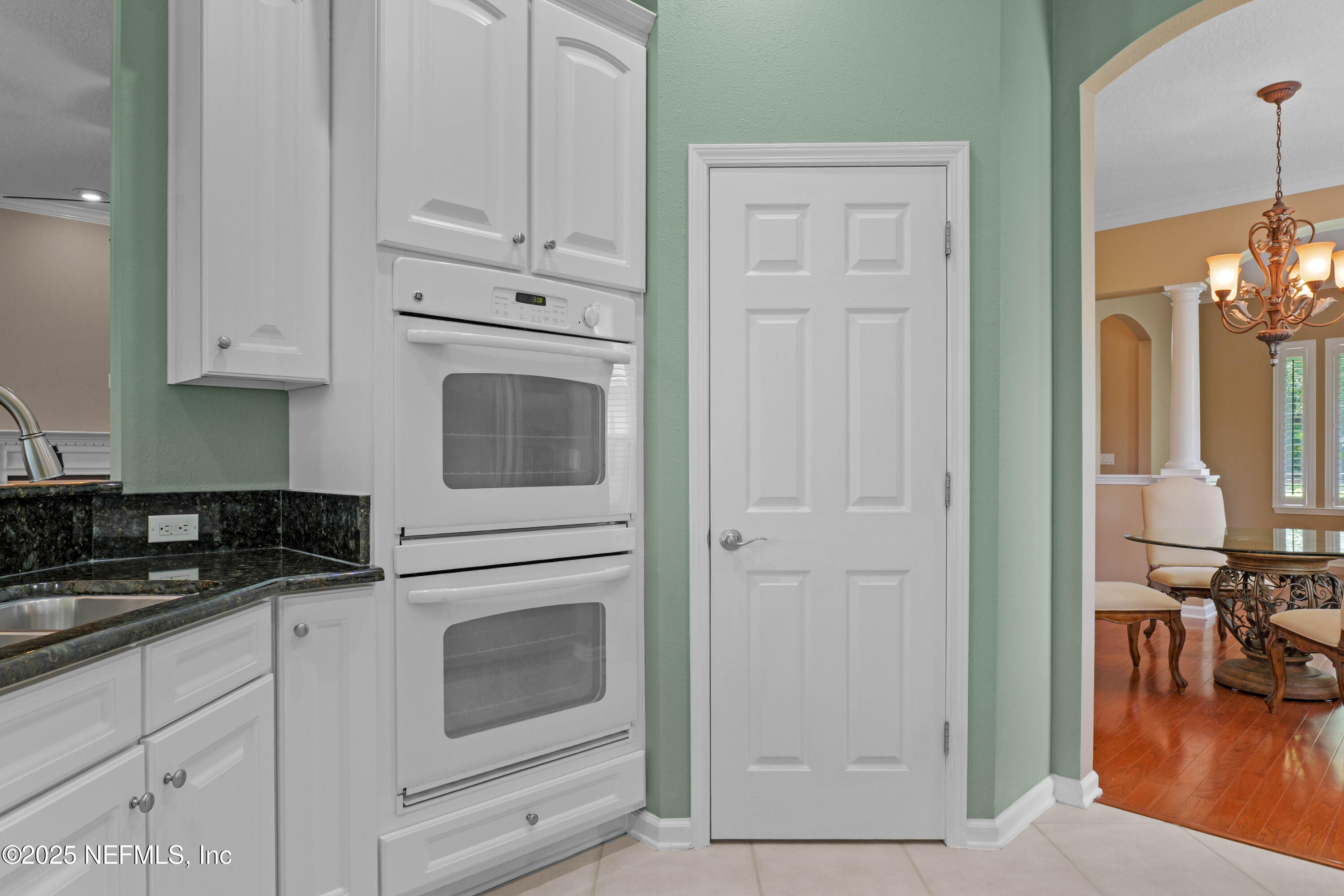 96218 Windsor Drive Yulee, FL 32097 - Photo 9 of 53 a kitchen with granite countertop white cabinets and stainless steel appliances