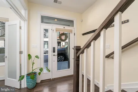 a view of an entryway with wooden floor and stairs