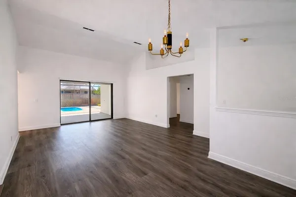 a view of a room with wooden floor and window