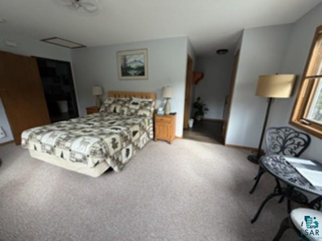 6266 Giants Ridge Road Biwabik, MN 55705 - Photo 20 of 30 Carpeted flooring extending through the room, light-toned walls, and wood-framed window