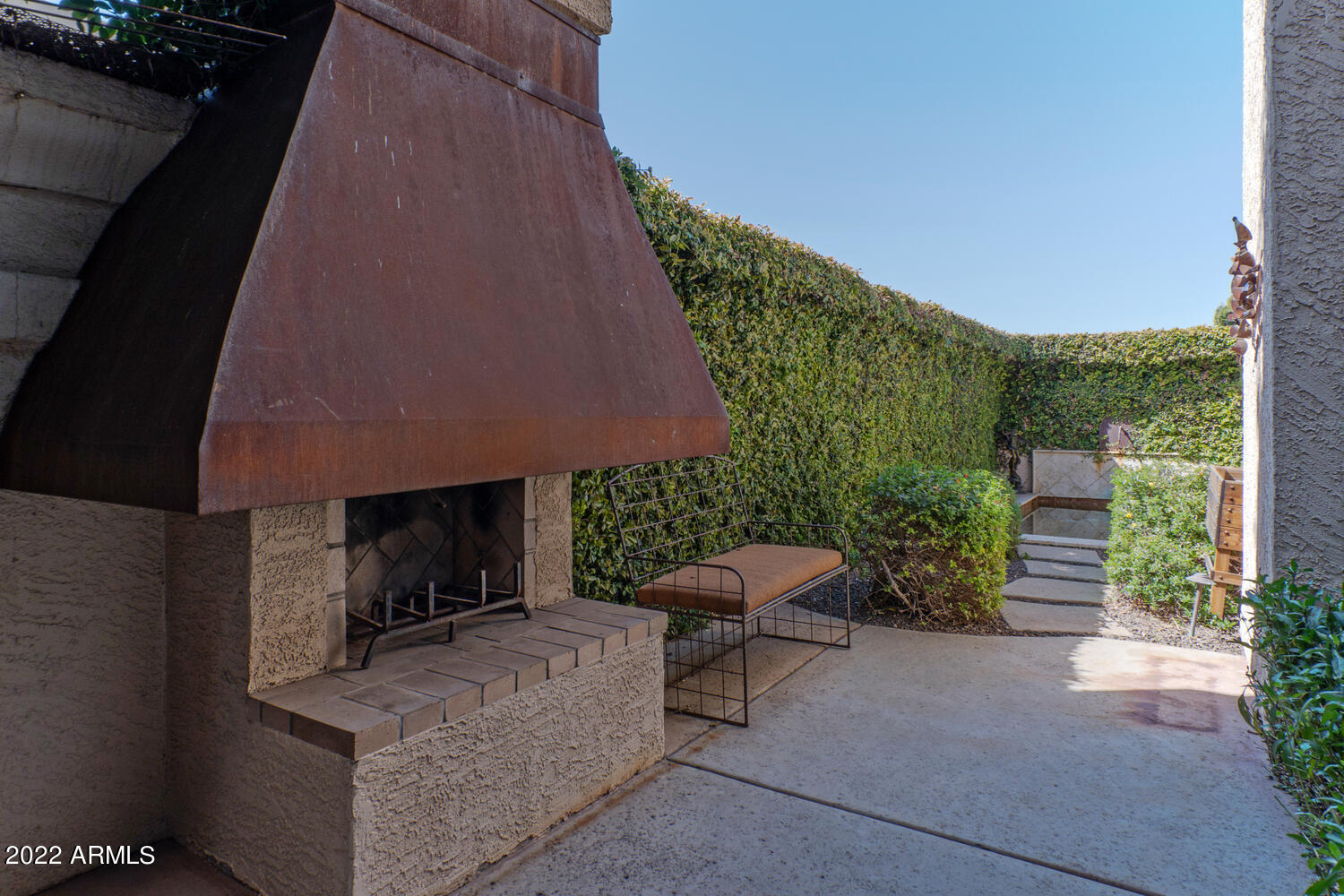 8100 East Camelback Road, Unit 39 Scottsdale, AZ 85251 - Photo 32 of 40 Courtyard fireplace with copper dome