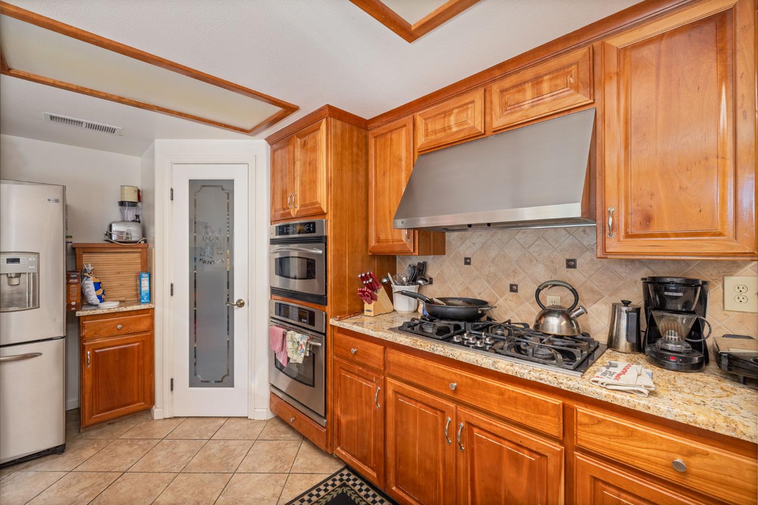 45544 Pine River Road Ahwahnee, CA 93601 - Photo 13 of 75 a kitchen with stainless steel appliances granite countertop a refrigerator and a sink