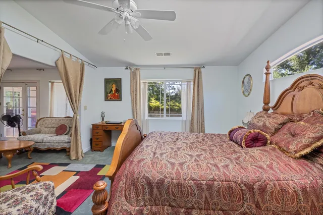 a view of a house with a yard and tree s