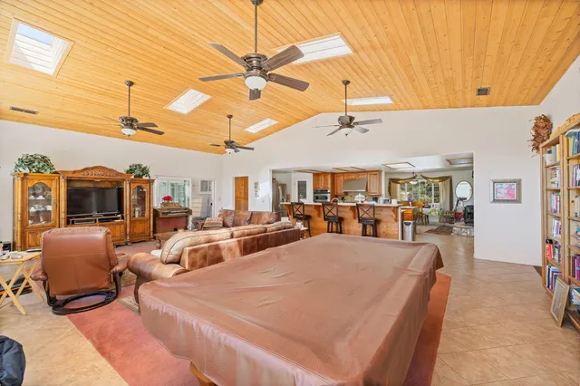 a living room with furniture a chandelier and a large window