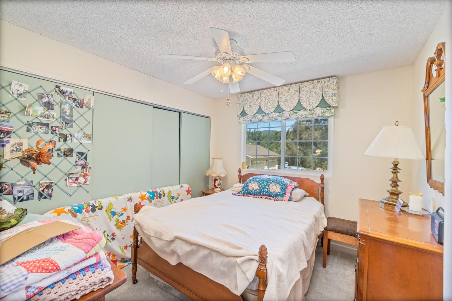 45544 Pine River Road Ahwahnee, CA 93601 - Photo 31 of 75 a bedroom with a bed and a chandelier